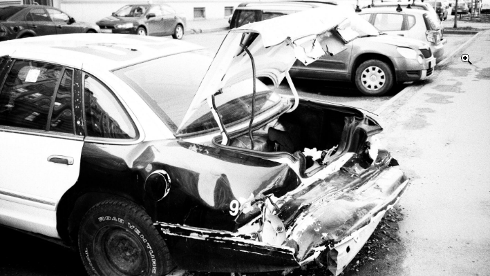 a black and white shot of a wrecked car